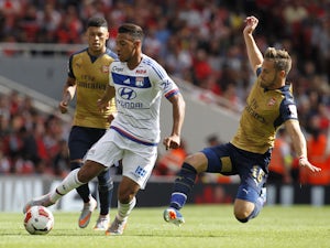 Lyon's French midfielder Corentin Tolisso vies with Arsenals Welsh midfielder Aaron Ramsey during the pre-season friendly football match between Arsenal and Lyon at The Emirates Stadium in north London on July 25, 2015