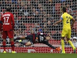Villarreal's midfielder Bruno Soriano (R) scores this penalty pastLyons goalkeeper Mathieu Gorgelin during the pre-season friendly football match between Lyon and Villarreal at The Emirates Stadium in north London on July 26, 2015