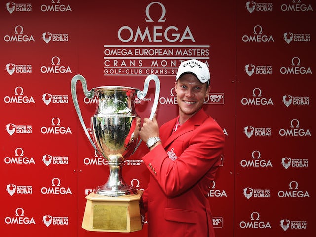 Danny Willett of England holds the trophy after winning the Omega European Masters at Crans-sur-Sierre Golf Club on July 26, 2015