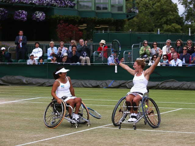 Yui Kamiji of Japan and Jordanne Whiley of Great Britain celebrate after winning the Wheelchair Ladies Doubles Final against Jiske Griffioen and Aniek Van Koot of the Netherlands during day thirteen of the Wimbledon Lawn Tennis Championships at the All En