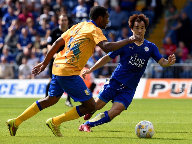 Shinji Okazak of Leicester City is challenged by Krystian Pearce of Mansfield Town during the pre season friendly match between Mansfield Town and Leicester City at the One Call Stadium on July 25, 2015