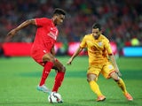 Joe Gomez of Liverpool is challenged by Sergio Cirio of United during the international friendly match between Adelaide United and Liverpool FC at Adelaide Oval on July 20, 2015