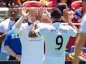 Wayne Rooney #10 of Manchester United high fives Memphis Depay #9 after scoring against Barcelona in the eighth minute during the International Champions Cup on July 25, 2015