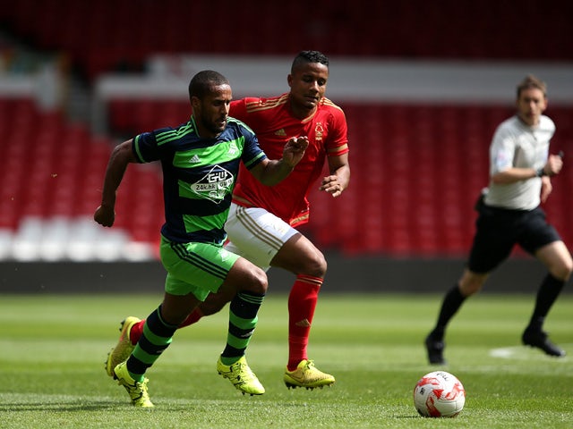 Wayne Routledge of Swansea City controls the ball from Michael Mancienne of Nottingham Forest during the pre season friendly match between Nottingham Forest and Swansea City at City Ground on July 25, 2015