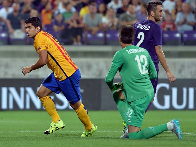 Barcelona's Uruguayan forward Luis Suarez (L) celebrates after scoring a goal during the International Champions Cup football match between Fiorentina and Barcelona at the Artemio Franchi Stadium in Florence on August 2, 2015