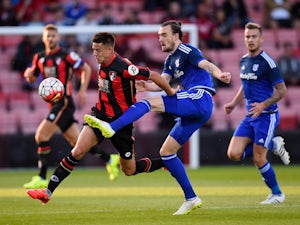 Harry Cornick of Bournemouth is challenged by Scott Malone of Cardiff City during a Pre Season Friendly between AFC Bournemouth and Cardiff City at Vitality Stadium on July 31, 2015