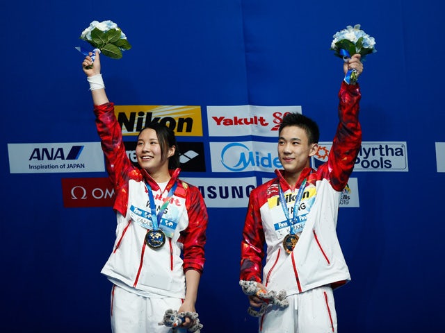 Gold medallists Han Wang and Hao Yang of China celebrate during the medal ceremony for the 3m Springboard Synchronised Mixed Diving Final on day nine of the 16th FINA World Championships at the Aquatics Palace on August 2, 2015