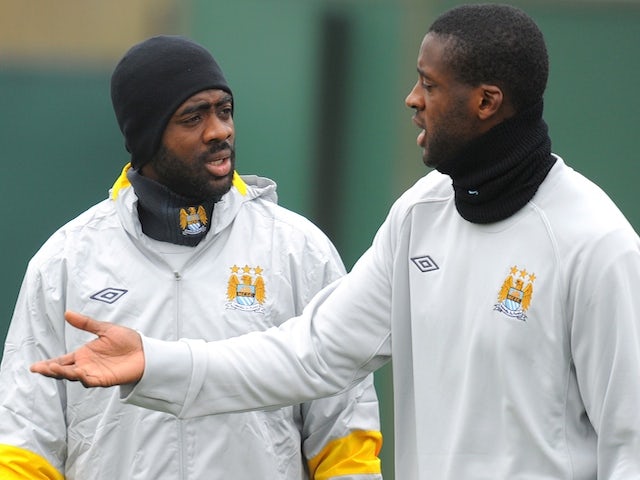 Manchester City's Ivorian defender Kolo Toure (L) and his brother Yaya Toure attend a team training session at the club's Carrington training complex, in Manchester, north-west England on March 16, 2011