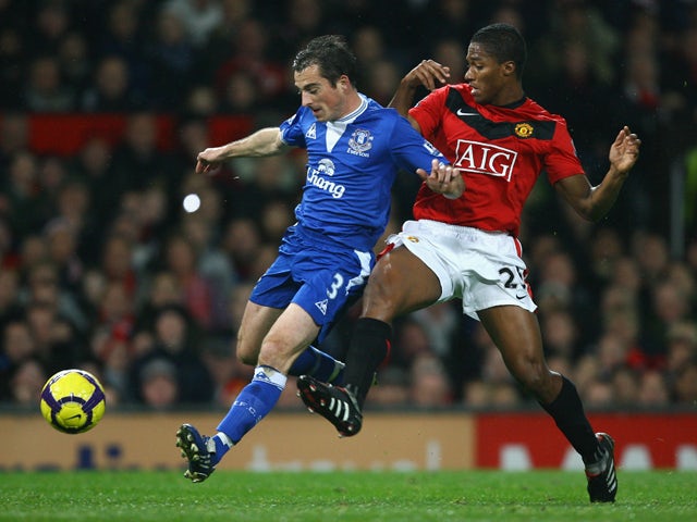 Leighton Baines of Everton competes for the ball with Antonio Valencia of Manchester United during the Barclays Premier League match between Manchester United and Everton at Old Trafford on November 21, 2009