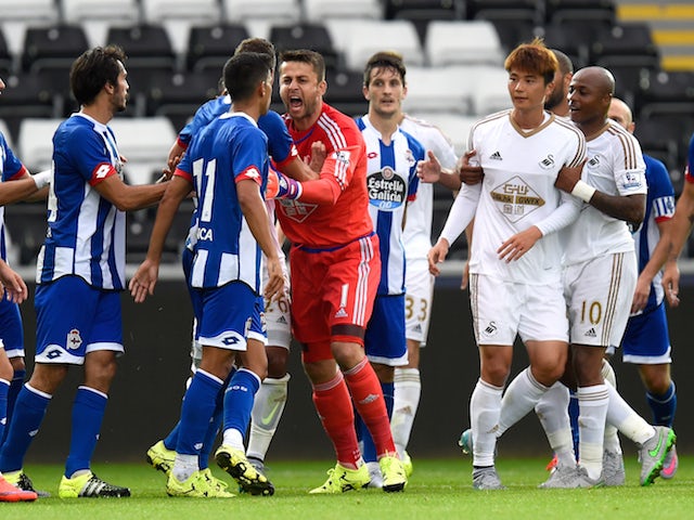 Swansea goalkeeper Lukasz Fabianski (red shirt) gets involved in a fracas during the Pre season friendly match between Swansea City and Deportivo La Coruna at Liberty Stadium on August 1, 2015