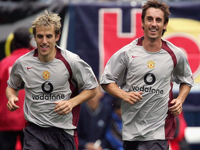 Phil Neville (L) and Gary Neville in action during training with Manchester United at Soldier Fields on July 24, 2004 
