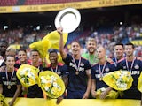 PSV Eindhoven's captain Luuk de Jong (C) shows the cup after winning the Dutch Super Cup football match between League champions Eindhoven and National Cup winner Groningen, in Amsterdam on August 2, 2015