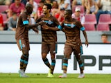 Maxi Pereira of Porto celebrates the second goal with Brahimi and Evandro of Porto during the Colonia Cup 2015 match between FC Porto and Stoke City FC at RheinEnergieStadion on August 2, 2015
