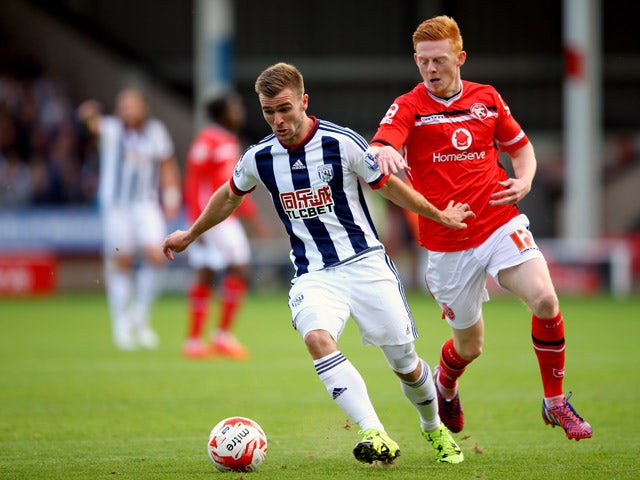 Callum McManaman of West Brom holds off Reece Flanagan of Walsall during the Pre-Season Friendly between Walsall and West Bromwich Albion at Banks' Stadium on July 28, 2015