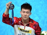 Chinese diver Xie Siyi poses with his gold medal during the podium ceremony of the Men's 1m Springboard final diving event at the 2015 FINA World Championships in Kazan on July 27, 2015