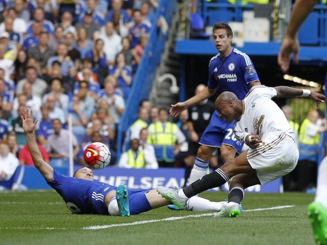 Swansea City's Ghanaian striker Andre Ayew scores an equalising goal to take the score to 1-1 during the English Premier League football match between Chelsea and Swansea City at Stamford Bridge in London on August 8, 2015