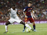 AS Roma's French defender Mapou Yanga-Mbiwa (L) vies with Barcelona's Argentinian forward Lionel Messi (R) during the 50th Joan Gamper Trophy football match FC Barcelona vs AS Roma at the Camp Nou stadium in Barcelona on August 5, 20