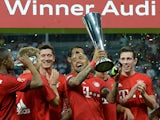 Bayern Munich's Chilean midfielder Arturo Vidal and his team-mates celebrate with the trophy after the Audi Cup final football match Real Madrid vs FC Bayern Munich in Munich, southern Germany, on August 5, 2015