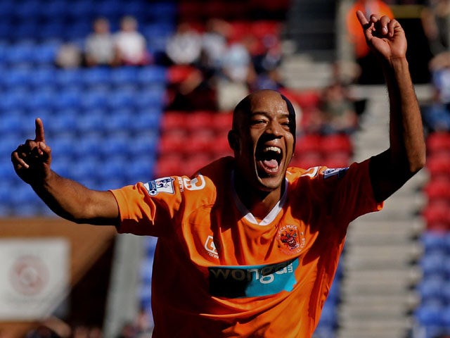 Alex Baptiste of Blackpool celebrates scoring his team's fourth goal during the Barclays Premier League match between Wigan Athletic and Blackpool at the DW Stadium on August 14, 2010