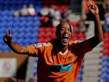Alex Baptiste of Blackpool celebrates scoring his team's fourth goal during the Barclays Premier League match between Wigan Athletic and Blackpool at the DW Stadium on August 14, 2010