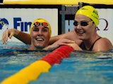 Australia's Cate Campbell (R) and Bronte Campbell (L) react at the end of a preliminary heat of the women's 100m freestyle swimming event at the 2015 FINA World Championships in Kazan on August 6, 2015