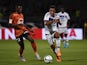 Lyon's French midfielder Corentin Tolisso (R) vies with Lorient's Cameroonian forward Benjamin Moukandjo (L) during the French Ligue1 football match between Olympique Lyonnais and FC Lorient on August 9, 2015
