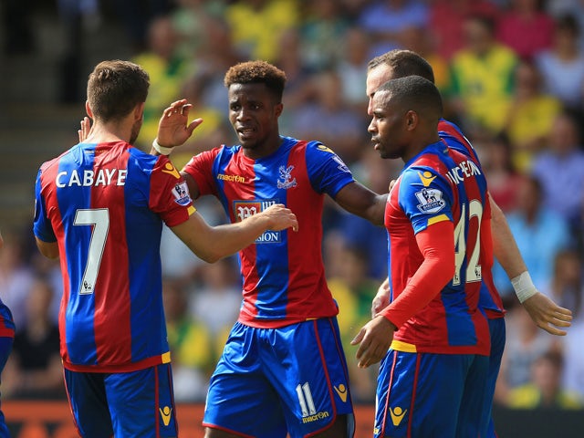 Wilfried Zaha of Crystal Palace celebrates scoring his team's first goal with his team mate during the Barclays Premier League match between Norwich City and Crystal Palace at Carrow Road on August 8, 2015 