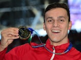A happy James Guy poses with his gold medal after winning the men's 200m freestyle at the World Aquatics Championships on August 4, 2015