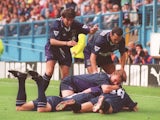 Jurgen Klinsmann of Tottenham is mobbed by teammates after scoring a goal during the FA Carling Premier League match between Sheffield Wednesday and Tottenham Hotspur at Hillsborough on August 20, 1994