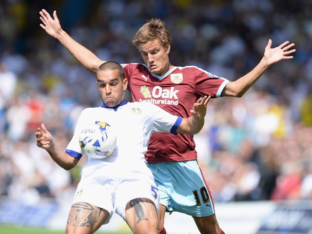 Giuseppe Bellusci (L) of Leeds United challenges Jelle Vossen of Burnley during the Sky Bet Championship match between Leeds United and Burnley at Elland Road on August 8, 2015