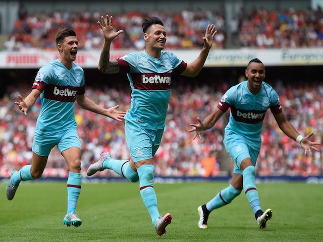 Mauro Zarate of West Ham United (C) celebrates with team mates as he scores their second goal during the Barclays Premier League match between Arsenal and West Ham United at the Emirates Stadium on August 9, 2015
