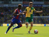Wilfried Zaha of Crystal Palace and Robbie Brady of Norwich City compete for the ball during the Barclays Premier League match between Norwich City and Crystal Palace at Carrow Road on August 8, 2015