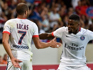 Paris Saint-Germain's Brazilian midfielder Lucas celebrates his goal with teammate French defender Serge Aurier during the French L1 football match between Lille and PSG on August 7, 2015
