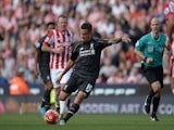 Liverpool's Brazilian midfielder Philippe Coutinho shoots to score the opening goal of the English Premier League football match between Stoke City and Liverpool at the Britannia Stadium in Stoke-on-Trent, central England on August 9, 2015