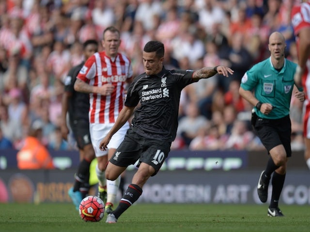 Liverpool's Brazilian midfielder Philippe Coutinho shoots to score the opening goal of the English Premier League football match between Stoke City and Liverpool at the Britannia Stadium in Stoke-on-Trent, central England on August 9, 2015