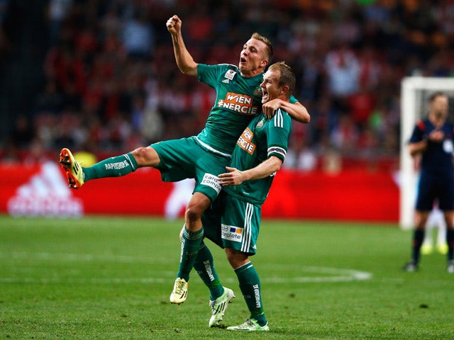 Christopher Dibon and Mario Sonnleitner of Rapid Wien celebrate after victory in the third qualifying round 2nd leg UEFA Champions League match between Ajax Amsterdam and SK Rapid Vienna held at Amsterdam ArenA on August 4, 2015