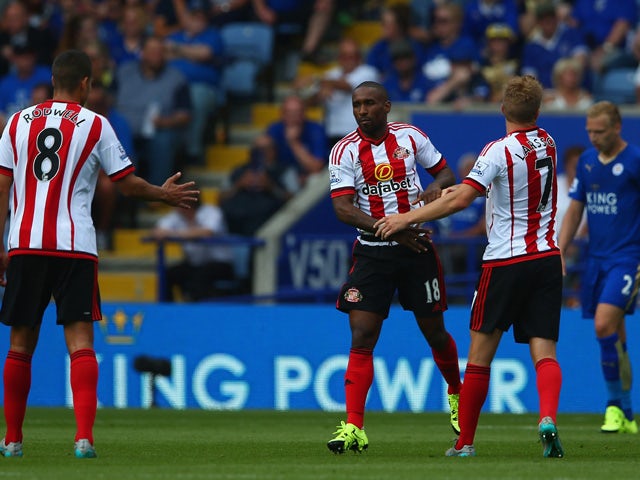Jermain Defoe of Sunderland celebrates scoring his team's first goal with his team mate Sebastian Larsson and Jack Rodwell during the Barclays Premier League match between Leicester City and Sunderland at The King Power Stadium on August 8, 2015