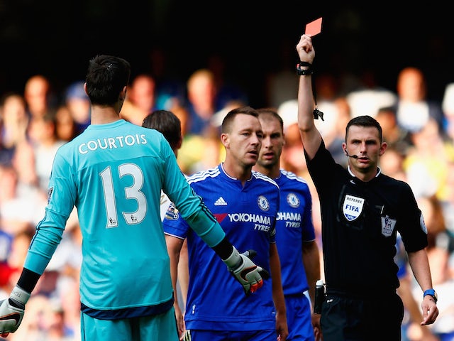 Thibaut Courtois (L) of Chelsea is shown the red card by referee Michael Oliver (R) during the Barclays Premier League match between Chelsea and Swansea City at Stamford Bridge on August 8, 2015