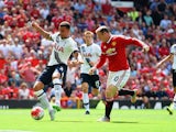 Kyle Walker (L) of Tottenham Hotspur kicks the ball resulting in the own goal during the Barclays Premier League match between Manchester United and Tottenham Hotspur at Old Trafford on August 8, 2015