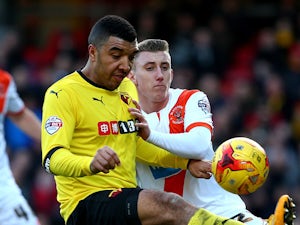 Troy Deeney of Watford looks to hold the ball up from Blackpool's David Ferguson during the Sky Bet Championship match between Watford and Blackpool at Vicarage Road on January 24, 2015
