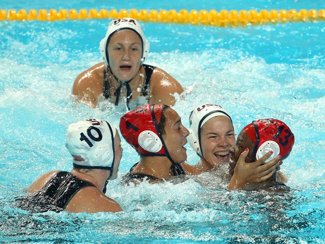 Samantha Hill #1 and Ashleigh Johnson #13 of the United States celebrate with their teammates after winning the gold medal match to defeat the Netherlands 5 to 4 on day fourteen of the 16th FINA World Championships at the Water Polo Arena on August 7, 201