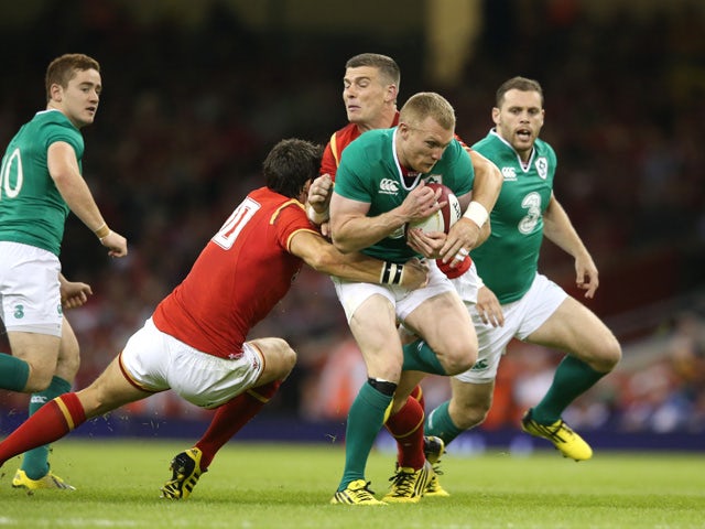 Keith Earls of Ireland is tackled by James Hook and Scott Williams during the International match between Wales and Ireland at the Millennium Stadium on August 8, 2015