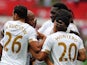 Andre Ayew is congratulated by teammates after scoring Swansea's second against Newcastle on August 15, 2015