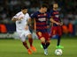 Lionel Messi of Barcelona holds off a challenge from Ever Banega of Sevilla during the UEFA Super Cup between Barcelona and Sevilla FC at Dinamo Arena on August 11, 2015