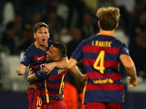 Lionel Messi of Barcelona is congratulated on scoring their first goal with Dani Alves of Barcelona during the UEFA Super Cup between Barcelona and Sevilla FC at Dinamo Arena on August 11, 2015