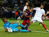 Rafinha of Barcelona scores the third goal under pressure from Beto and Coke of Sevilla during the UEFA Super Cup between Barcelona and Sevilla FC at Dinamo Arena on August 11, 2015