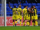 Goalkeeper Ben Amos of Bolton Wanderers looks dejected as Matt Palmer of Burton Albion (obscured) celebrates with team mates as he scores their first goal during the Capital One Cup first round match between Bolton Wanderers and Burton Albion at Macron St