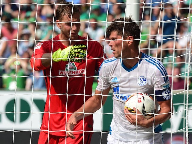 Bremen's goalkeeper Felix Wiedwald shoves Schalke's Dutch striker Klaas-Jan Huntelaar after conceding an own goal on August 15, 2015
