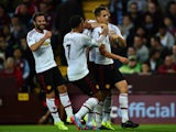 Adnan Januzaj of Manchester United celebrates scoring the opening goal with Memphis Depay and Juan Mata of Manchester United during the Barclays Premier League match between Aston Villa and Manchester United on August 14, 2015