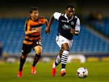 Fred Onyedinma of Millwall moves away from Luke Gambin of Barnet during the Capital One Cup First Round match between Millwall and Barnet at The Den on August 11, 2015